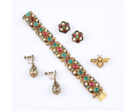 A Czechoslovakian gilt metal enamel and stone set bracelet, with five articulated links each set with a central oval red ston