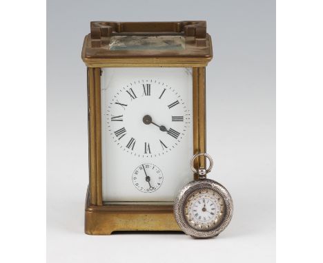 An early 20th Century brass carriage clock with black Roman numeral hourly markers with minute track border and subsidiary di