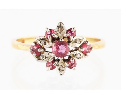 A 9ct yellow gold ruby and diamond cluster ring, set with a central round cut ruby, surrounded by alternating round cut rubie