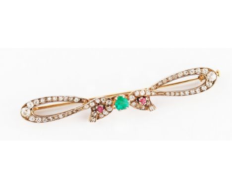 A yellow metal emerald, ruby and diamond pin brooch, set centrally with a round cut emerald flanked to either side with a rou