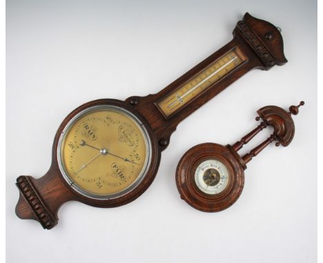 A lot to include; oak bodied barometer and thermometer with another thermometer with turned column body, together with an oak