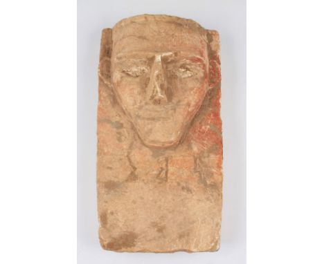 A near Eastern Arabian limestone carved stele decorative plaque with craved stylised head to upper body with three incised an