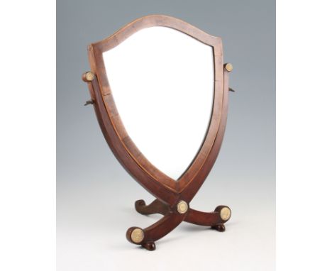 A Georgian mahogany miniature dressing mirror, shield shape with cross banding and satinwood stringing, turned ivory roundels