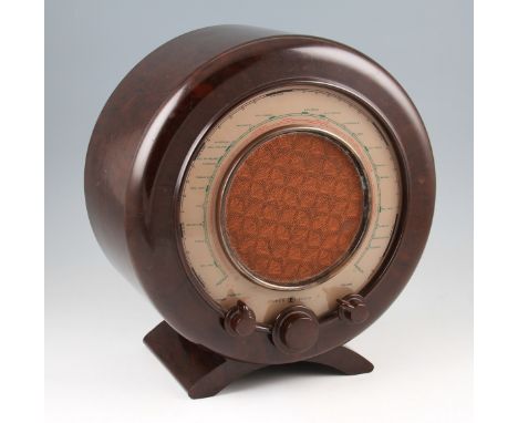 A mid 20th Century Ekco A22 bakelite cased radio of circular form with central speaker plus three knobs, all on two shaped fe