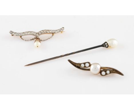 An early 20th Century white and yellow metal diamond and pearl set pin brooch, the bracket shaped motif set with 21 rough cut