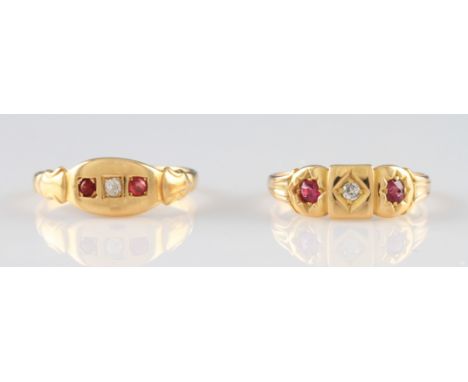 A yellow metal diamond and ruby ring, set with a central old cut diamond flanked by two star set round cut rubies, in a circl