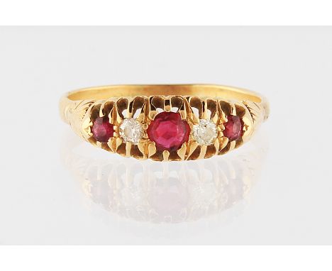 An 18ct yellow gold ruby and diamond ring, set with a central round cut ruby flanked with two Swiss cut diamonds and a round 