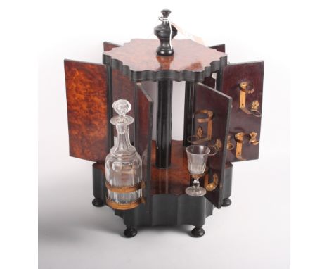 A 19th Century amboyna hexagonal drinks cabinet, base inset musical box, and a 19th Century mahogany decanter box with three 