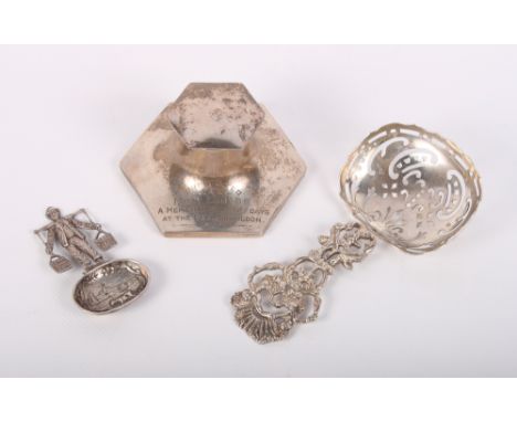 A Dutch cast silver spoon with milkman, a Dutch cast and pierced silver sifter spoon and a hexagonal Capstan inkwell