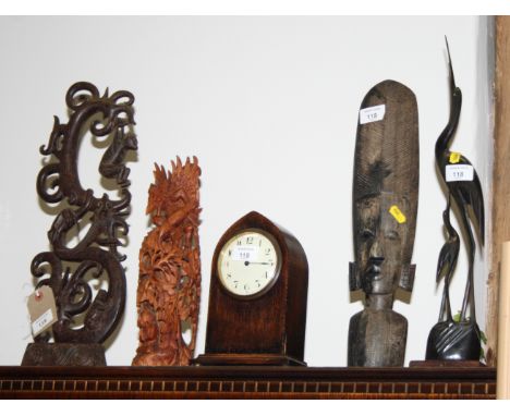 A wooden tribal head carving, an Indian wooden carving, a Far Eastern wooden carving with a hanging monkey and other animals,