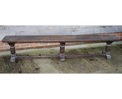 A 19th Century pine bench, on turned end supports, 87" long