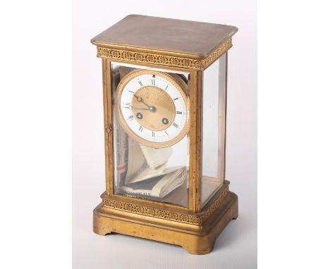 A late 19th Century brass cased four-glass mantel clock with white enamel dial and Roman and Arabic numerals, 11" high