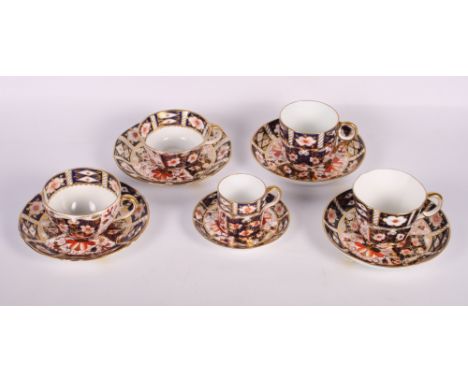 A pair of Crown Derby teacups and saucers, pattern 2451, two similar coffee cups and saucers and a matching coffee can and sa