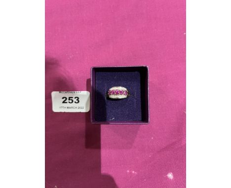 A pink and white stone ring. In gold marked 375. 2g gross. Size K
