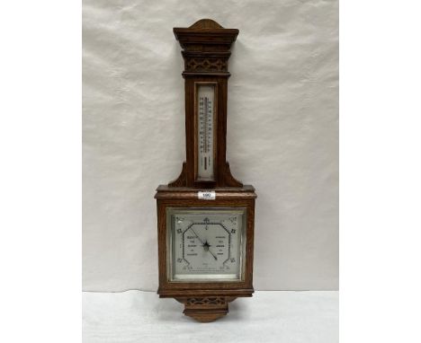 An early 20th century oak aneroid wall barometer. 27½'