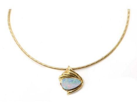 A 14ct gold opal pendant, a boulder opal or opal doublet, approximately 18 x 11mm, rub set, to fluted surmount and concealed 