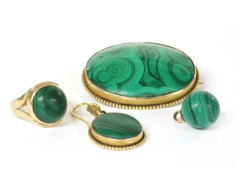 A Victorian gold malachite brooch, an oval cabochon malachite, rub set to beaded border, with pin and 'C' catch, tested as ap