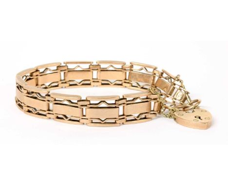 A rose gold gate bracelet, a wide central link, with shaped wire links either side and plain outer links, to heart shaped pad