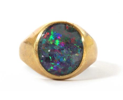 A 9ct gold opal triplet signet ring, an oval opal triplet, rub set, to tapered shoulders and a plain shank, Birmingham 1992, 