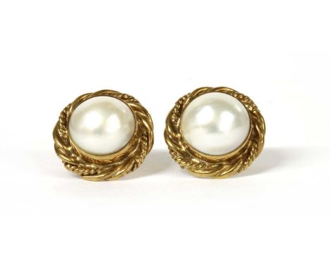 A pair of gold mabé pearl earrings, with a mabé pearl, approximately 14mm diameter, rub set to a twisted wire effect border, 