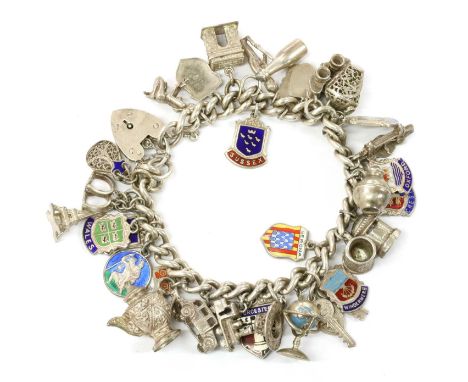 A silver charm bracelet, a sterling silver curb link bracelet with heart shaped padlock clasp, Birmingham 1957, suspending th