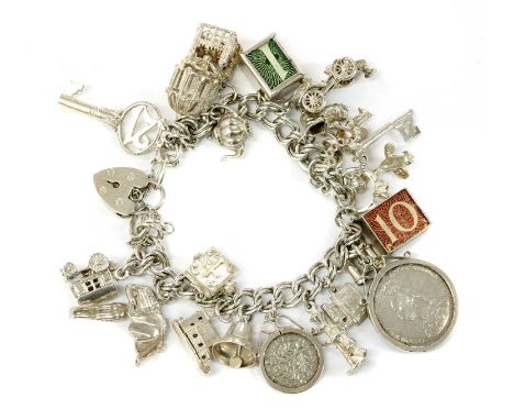 A sterling silver charm bracelet, the double link curb bracelet with heart shaped padlock clasp, Birmingham 1972, suspending 