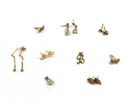 A quantity of gold earrings, to include a pair of diamond set drop earrings with post fittings, a pair of floral stud earring