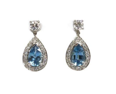 A pair of 18ct white gold aquamarine and diamond drop earrings, with a pear mixed cut aquamarine, claw set to a raised collet