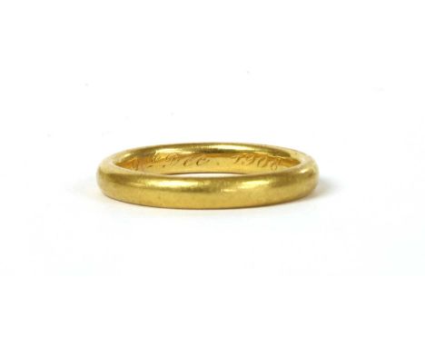 A gold light court section wedding ring, engraved to the inside 9th Dec 1908, marked 22, tested as approximately 22ct gold, 3