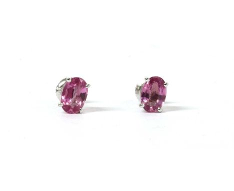 A pair of white gold single stone pink sapphire stud earrings, with an oval mixed cut pink sapphire, approximately 6 x 4mm, f