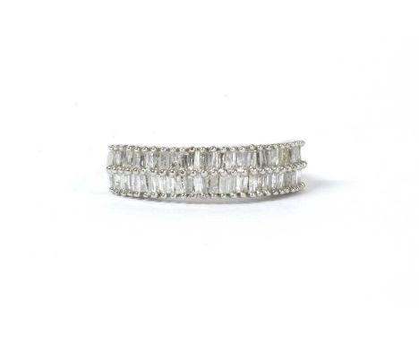 A silver two row diamond eternity ring, with two rows of baguette cut and tapered baguette cut diamonds, with a stated total 