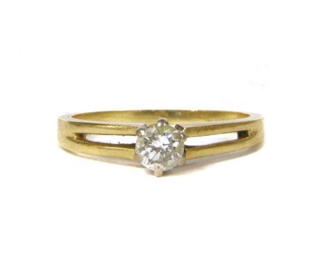 An 18ct gold single stone diamond ring, a round brilliant cut diamond, estimated as approximately 0.26ct, claw set in a high,