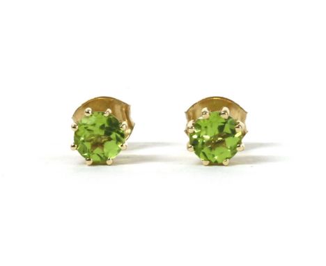 A pair of gold single stone peridot stud earrings, with a circular mixed cut peridot, approximately 5mm, eight claw set to po