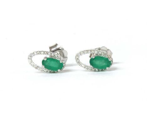 A pair of white gold emerald and diamond open halo cluster stud earrings, an oval mixed cut emerald, approximately 5 x 3mm, c