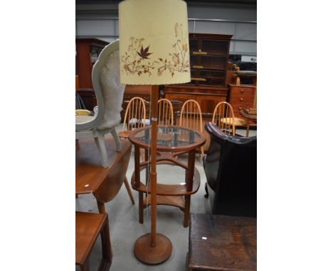 A vintage standard lamp with pressed leaf shade