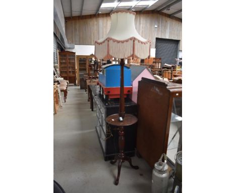 An early 20th Century mahogany standard lamp table having turned column and triple splay legs