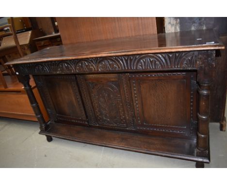 An early 20th century oak sideboard/dresser base having Gothic styled carved panel with cupboards under , approx. W163 H92 D5