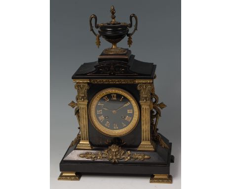 A late 19th century French black slate and bronze mounted mantel clock, of architectural form, with urn finial and floral mas