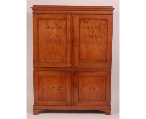 A Victorian oak estate cabinet, the upper section with twin panelled doors (later stencilled) enclosing three flights of grad