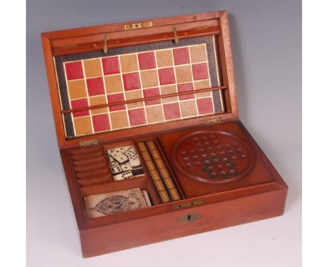 A late Victorian mahogany cased fitted games compendium, the hinged cover opening to reveal gilt tooled leather chessboard, t