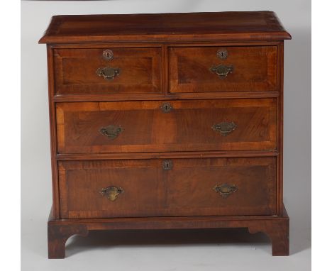 An 18th century figured walnut and crossbanded chest, of two short over two long drawers, raised on bracket supports (with la