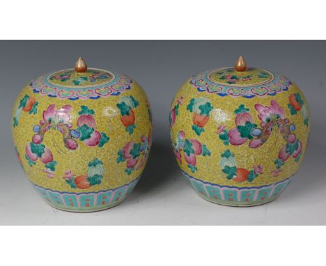 A pair of late 19th century Chinese stoneware ginger jars and covers, each of bulbous form with floral enamel decoration to a