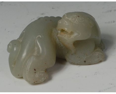 A 19th century Chinese carved and polished celadon jade figure of a dragon, with russet inclusions, w.7cm Condition Report / 