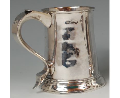 An early George III silver tankard, having double monogrammed S scroll handle and on stepped flaring foot, 11.9oz, maker Thom