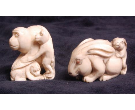A Japanese carved ivory netsuke of a monkey family group, signed verso, h.3.5cm; and one other of a rabbit family group, sign