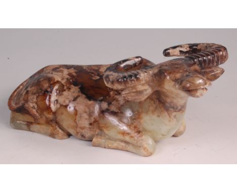 A Chinese carved jade water buffalo, with russet brown inclusions, in recumbent pose, 23cm  Condition Report / Extra Informat