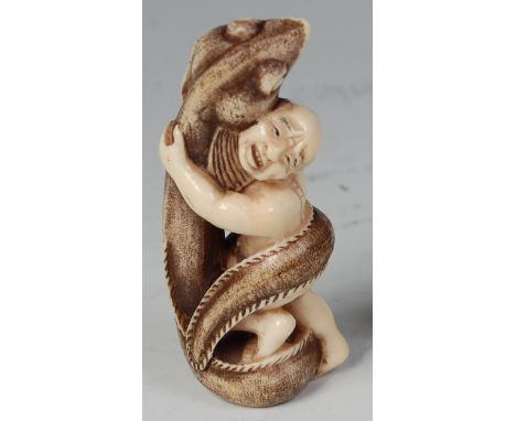 A Japanese Meiji period carved ivory netsuke, of a man wrestling a large eel, signed in script to the feet verso, h.6.8cm Con
