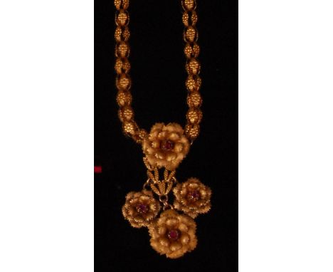 An antique yellow metal cage link necklace, set with a centre flower head supporting three further flower heads, each with ce