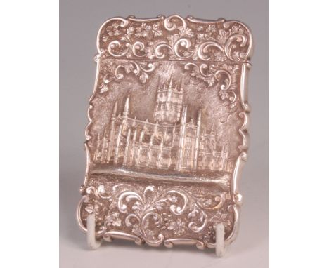 An early Victorian silver card case by Nathaniel Mills of Birmingham, depicting Worcester Cathedral within a C-scroll and aca