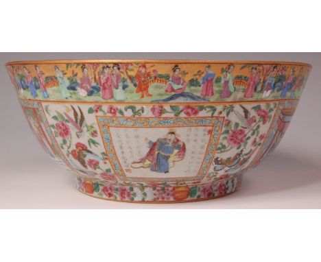 A 19th century Chinese Canton footed punch bowl, decorated in bright enamels with reserves of figure scenes within borders of